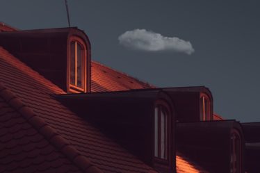 a view of the roof of a house at night