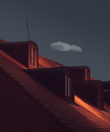 a view of the roof of a house at night